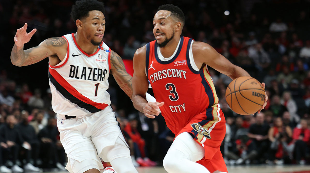 New Orleans Pelican Gard CJ McCollum (3) Drives on Portland Trail Blazers Guard Anfernee Simons (1) In the first half at the Modu Center. 