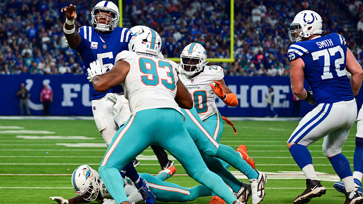 Oct 20, 2024; Indianapolis, Indiana, USA; Indianapolis Colts quarterback Anthony Richardson (5) throws a pass over Miami Dolphins defensive tackle Calais Campbell (93) before getting sacked during the second half at Lucas Oil Stadium. 