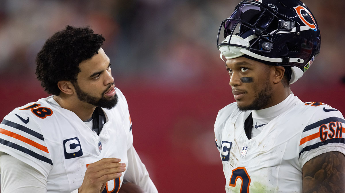Chicago Bears quarterback Caleb Williams (18) talks with wide receiver DJ Moore (2) against the Arizona Cardinals at State Farm Stadium.