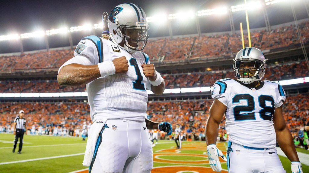 Carolina Panthers quarterback Cam Newton (1) does his Superman pose as he celebrates his second quarter touchdown with running back Jonathan Stewart (28) against the Denver Broncos at Sports Authority Field at Mile High.