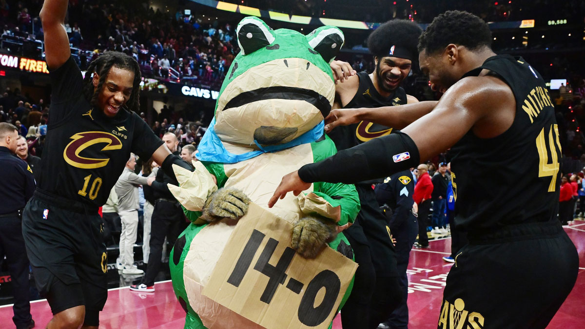 Cleveland Cavaliers guard Darius Garland (10) and center Jarrett Allen (31) and guard Donovan Mitchell (45) celebrate with Moondog after the Cavs defeated the Chicago Bulls and moved to 14-0 on the season at Rocket Mortgage FieldHouse.