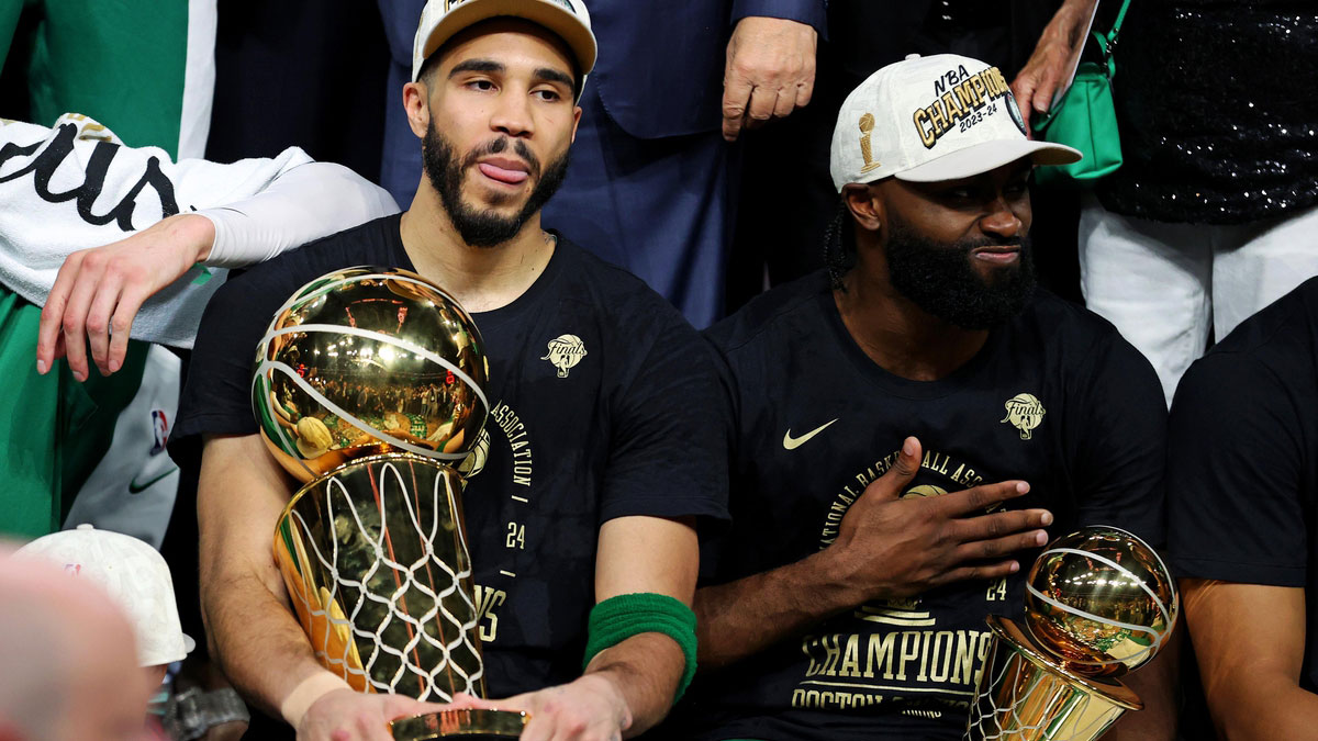 Boston Celtics forward Jayson Tatum (0) and guard Jaylen Brown (7) celebrates with the Larry O’Brian Trophy after beating the Dallas Mavericks in game five of the 2024 NBA Finals to win the NBA Championship at TD Garden