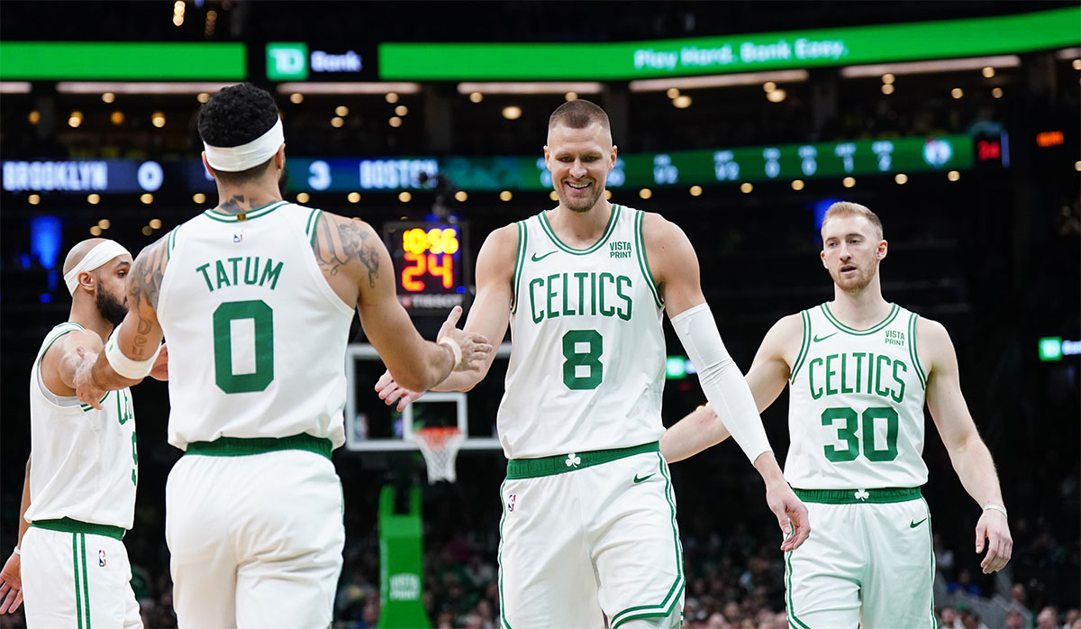 Boston Celtics center Kristaps Porzingis (8) and forward Jayson Tatum (0) react after a play against the Brooklyn Nets in the first half at TD Garden