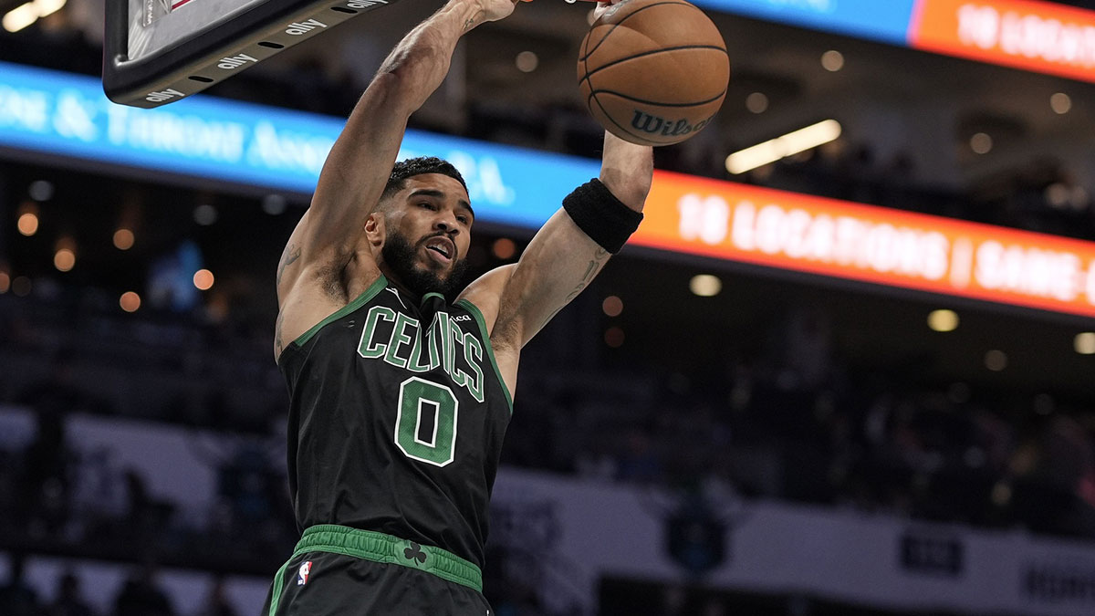 Boston Celtics forward Jayson Tatum (0) gets a fast break dunk against the Charlotte Hornets during the first quarter at the Spectrum Center