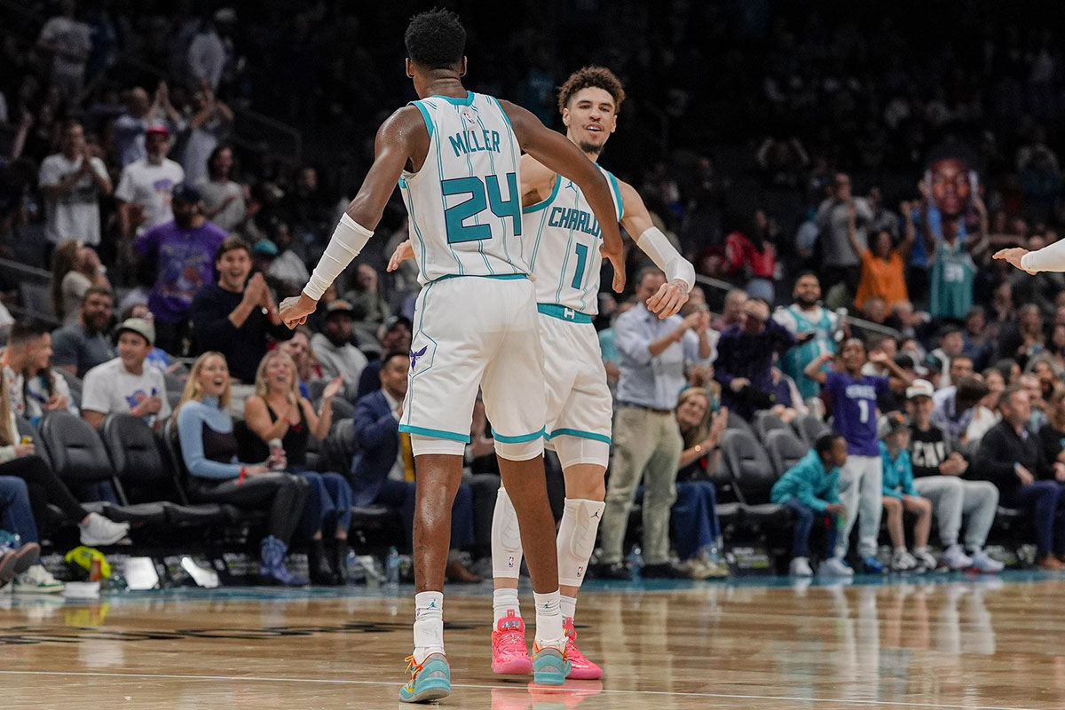 Charlotte Hornets forward Brandon Miller (24) and guard LaMelo Ball (1) high five after a dunk and assist during the second half against the Detroit Pistons at Spectrum Center.