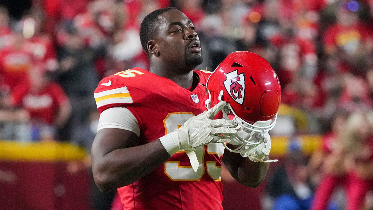 Kansas City Chiefs defensive tackle Chris Jones (95) removes his helmet during a timeout against the New Orleans Saints during the game at GEHA Field at Arrowhead Stadium.