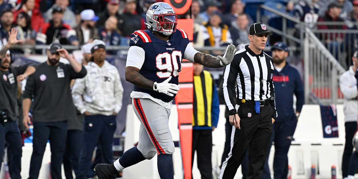 New England Patriots defensive tackle Christian Barmore (90) runs onto the field during the second half against the Los Angeles Rams at Gillette Stadium.