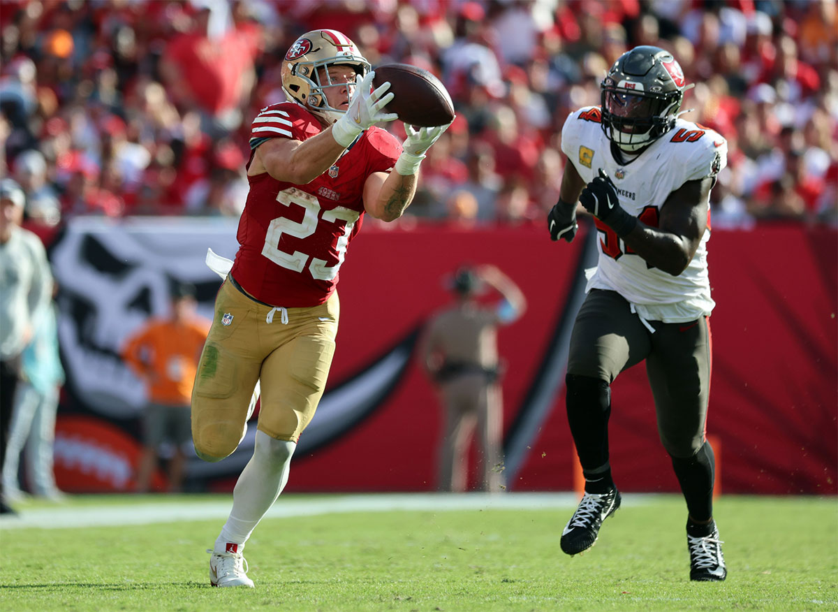 San Francisco 49ers running back Christian McCaffrey (23) catches the ball over Tampa Bay Buccaneers linebacker Lavonte David (54) during the second half at Raymond James Stadium.