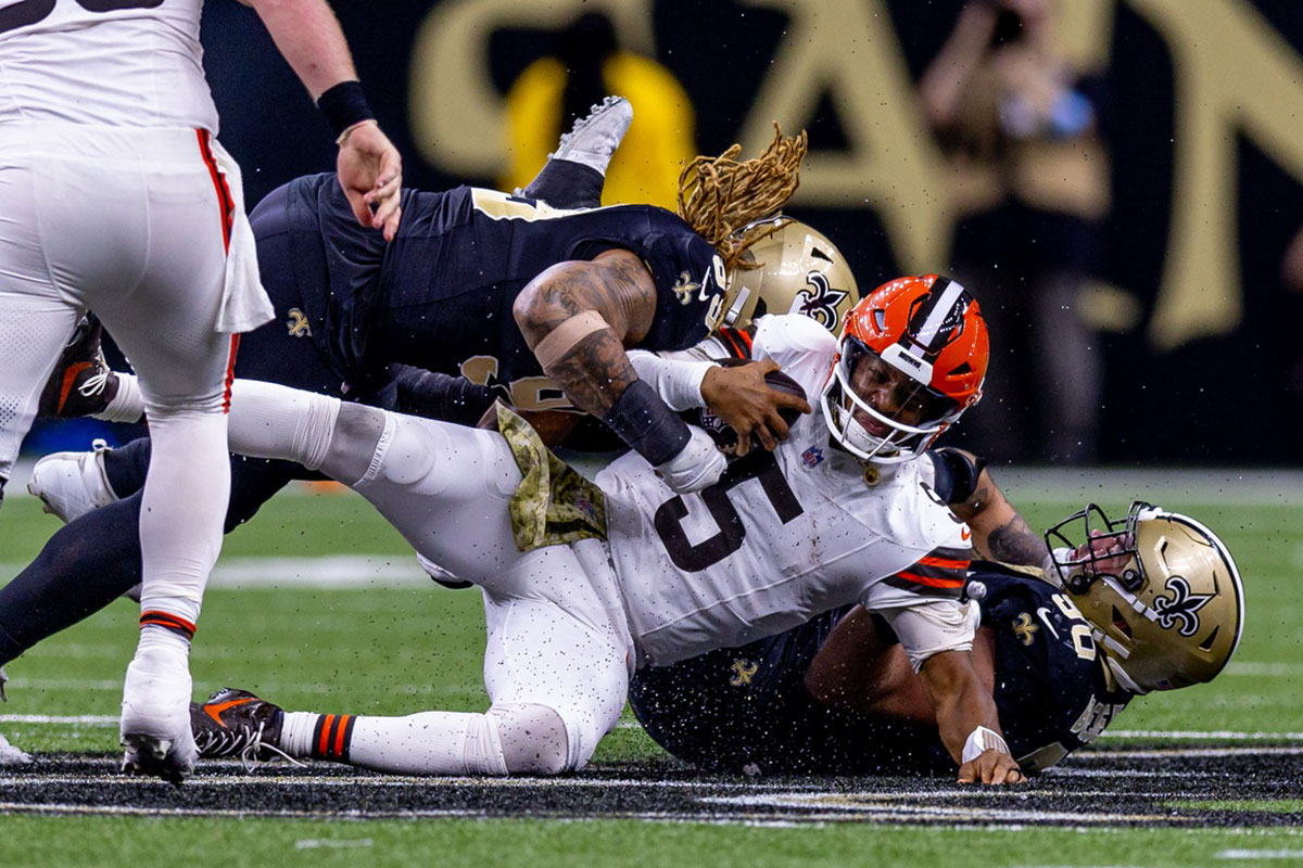 New Orleans Saints defensive end Chase Young (99) and defensive tackle Bryan Bresee (90) tackle Cleveland Browns quarterback Jameis Winston (5) during the second half at Caesars Superdome.