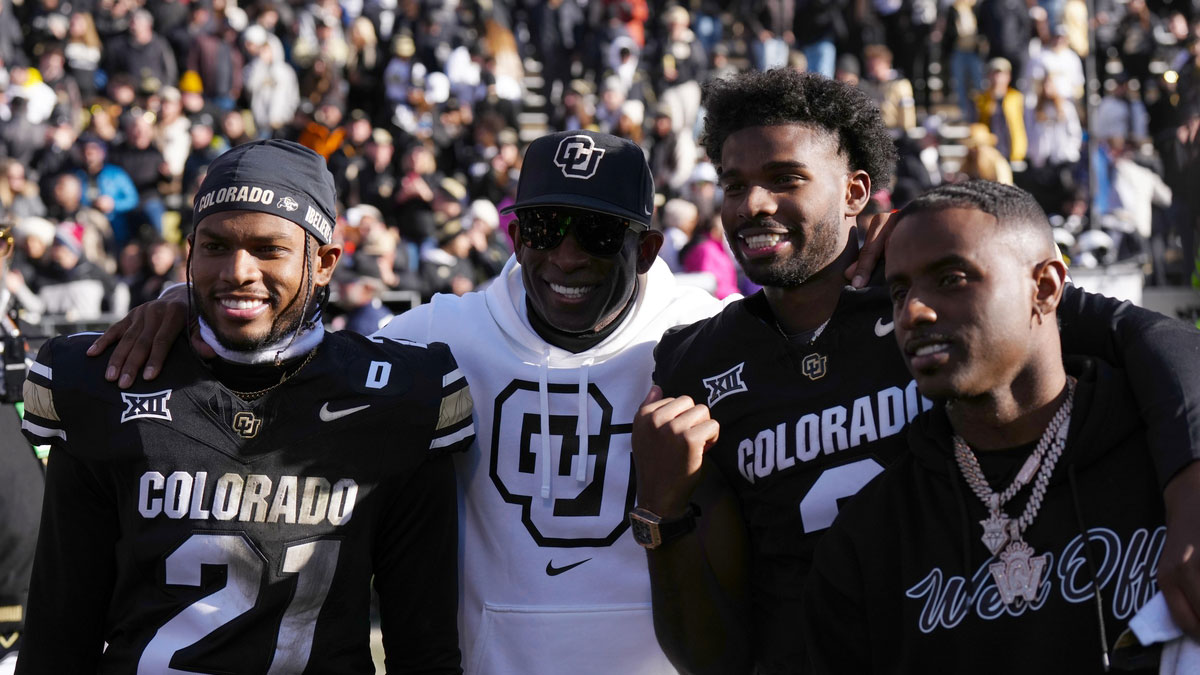 Buffaloes safety Shilo Sanders (21) and head coach Deion Sanders and quarterback Shedeur Sanders (2) and social media producer Deion Sanders Jr. following the win against the Oklahoma State Cowboys at Folsom Field