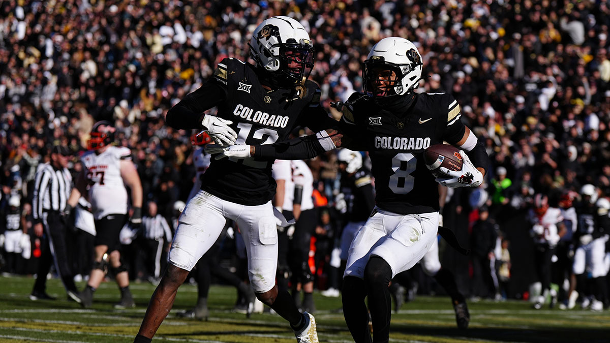 Colorado Buffaloes cornerback DJ McKinney (8) celebrates his interception with wide receiver Travis Hunter (12) in the second half against the Oklahoma State Cowboys at Folsom Field.