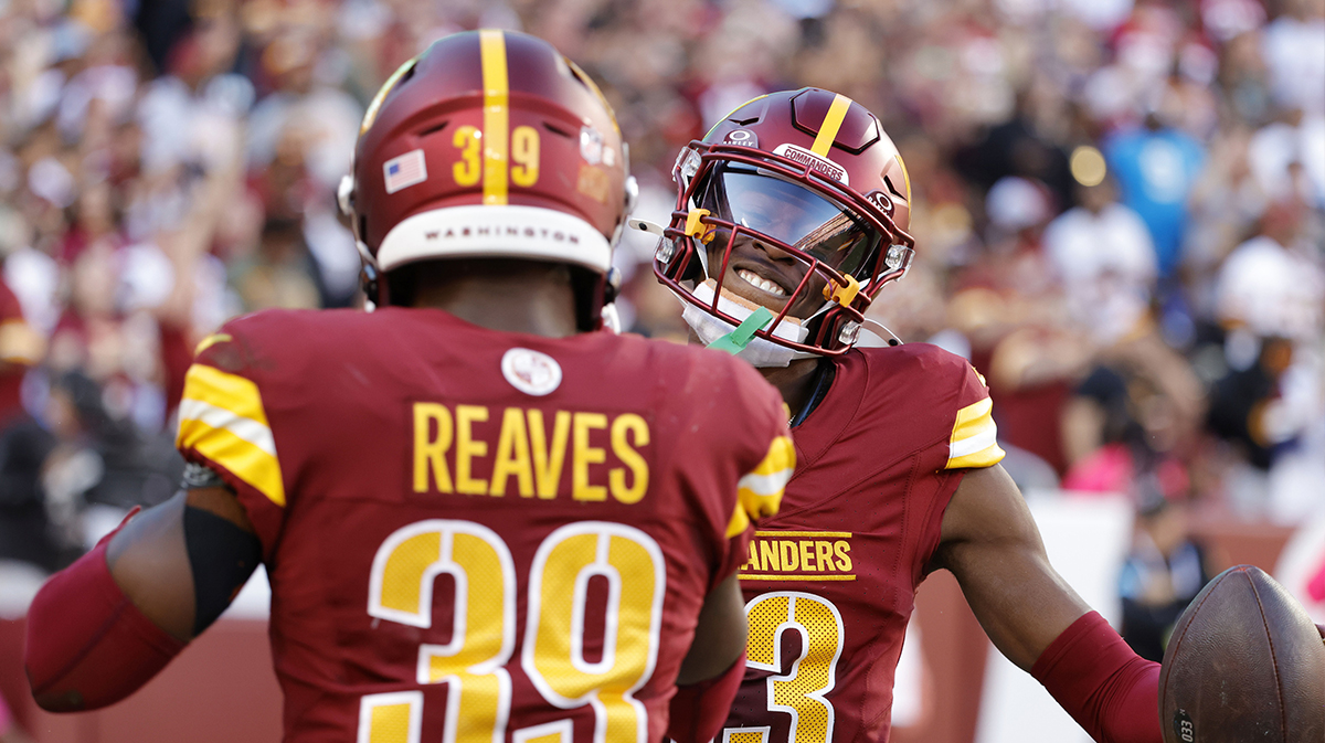 Emmanuel Forbes Jr. (13) celebrates with Commanders safety Jeremy Reaves (39) after intercepting a pass against the Carolina Panthers during the first quarter at Northwest Stadium