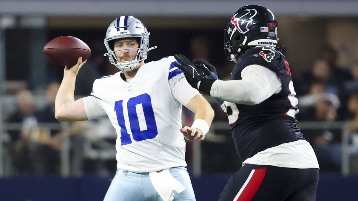 Dallas Cowboys quarterback Cooper Rush (10) throws as Houston Texans defensive tackle Tim Settle Jr. (98) defends during the second half at AT&T Stadium.