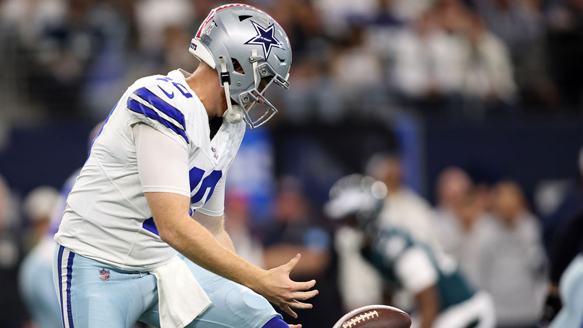 Nov 10, 2024; Arlington, Texas, USA; Dallas Cowboys quarterback Cooper Rush (10) fumbles the ball against the Philadelphia Eagles in the first quarter at AT&T Stadium.
