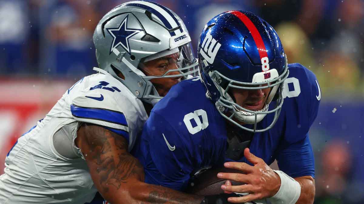 New York Giants quarterback Daniel Jones (8) is sacked by Dallas Cowboys linebacker Micah Parsons (11) during the first half at MetLife Stadium.