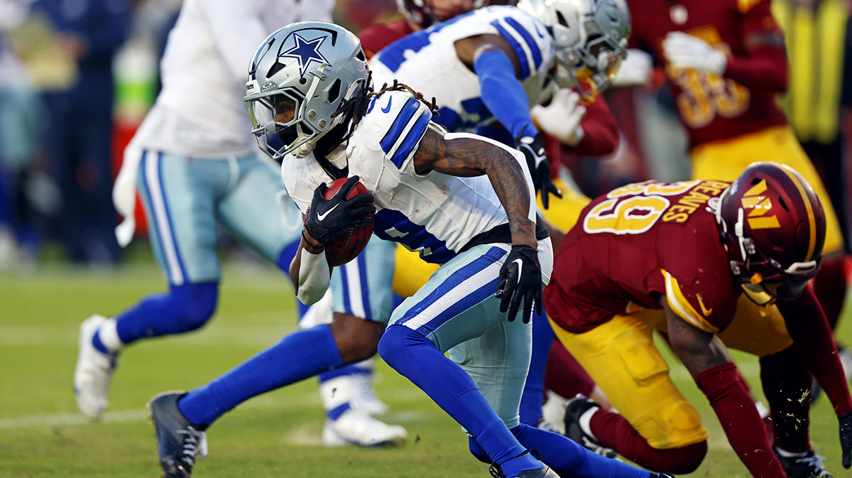 Dallas Cowboys wide receiver KaVontae Turpin (9) breaks a tackle by Washington Commanders safety Jeremy Reaves (39) to run for a touchdown on a kickoff return during the fourth quarter at Northwest Stadium.