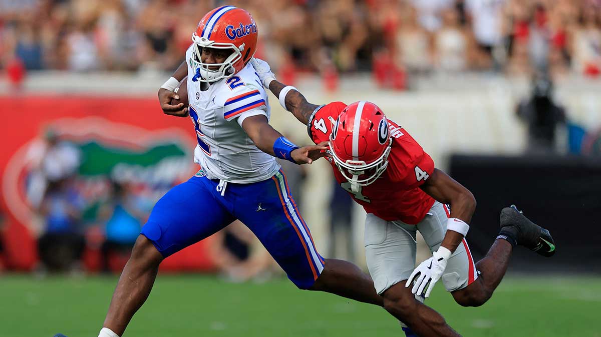 Florida Gators quarterback DJ Lagway (2) fends off Georgia Bulldogs defensive back KJ Bolden (4) during the second quarter of an NCAA college football matchup Saturday, Nov. 2, 2024 at EverBank Stadium in Jacksonville, Fla. The Georgia Bulldogs defeated the Florida Gators 34-20.