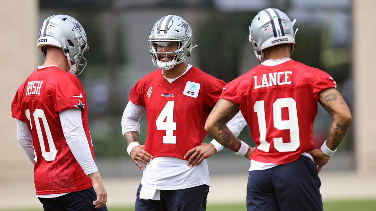 Dallas Cowboys quarterback Cooper Rush (10) and quarterback Dak Prescott (4) and quarterback Trey Lance (19) talk during practice at the Ford Center at the Star Training Facility in Frisco, Texas.