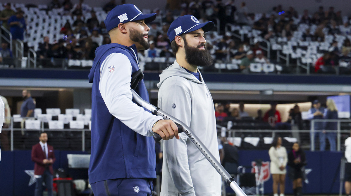 Nov 18, 2024; Arlington, Texas, USA; Dallas Cowboys quarterback Dak Prescott (left) stands on crutches before the game against the Houston Texans at AT&T Stadium.