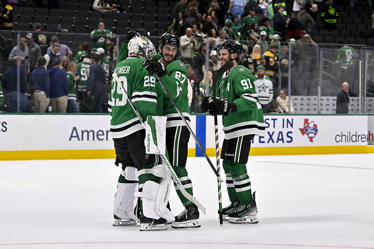 Dallas Stars goaltender Jake Oettinger (29) and left wing Mason Marchment (27) and center Tyler Seguin (91) celebrate the win over the Boston Bruins at the American Airlines Center.