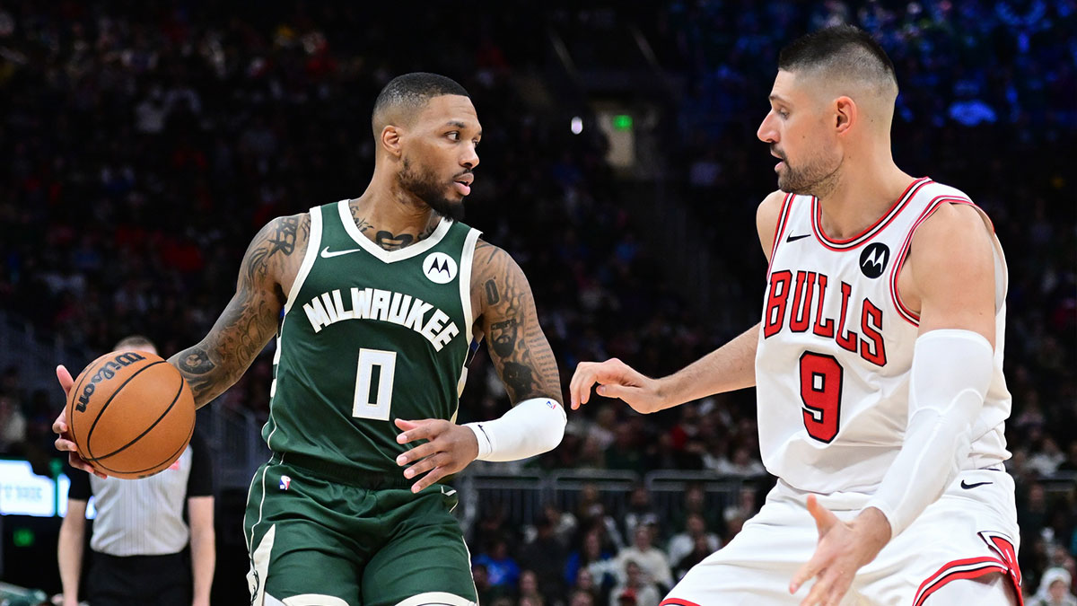 Milwaukee Bucks guard Damian Lillard (0) drives against Chicago Bulls center Nikola Vucevic (9) in the fourth quarter at Fiserv Forum.