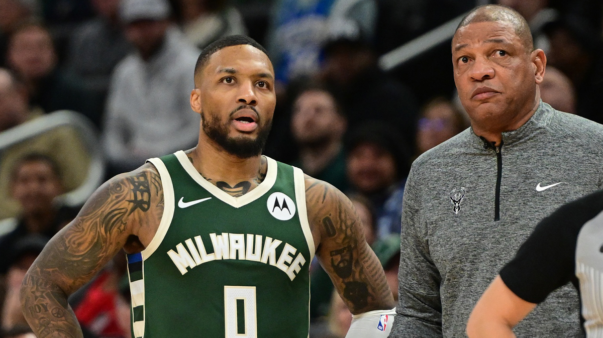 Milwaukee Bucks guard Damian Lillard (0) looks on with head coach Doc Rivers during a timeout in the fourth quarter against the Chicago Bulls at Fiserv Forum