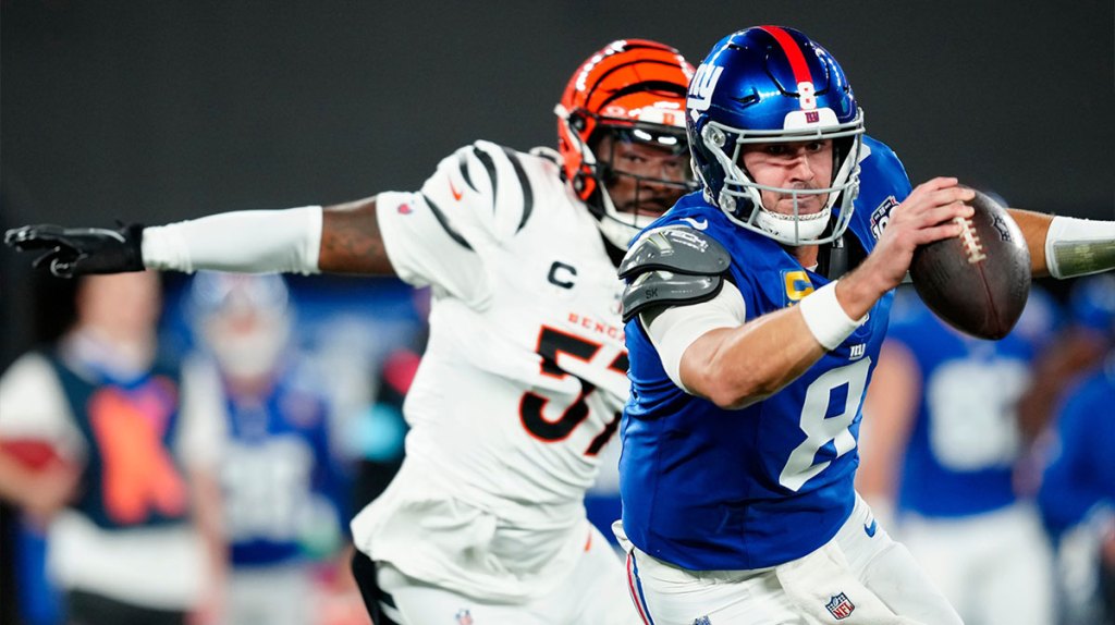New York Giants quarterback Daniel Jones (8) tries to run away as he gets into trouble near Cincinnati Bengals linebacker Germaine Pratt (57), Sunday, October 13, 2024, in East Rutherford.