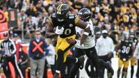 Pittsburgh Steelers tight end Darnell Washington (80) runs for extra yardage while being chased by Baltimore Ravens linebacker Malik Harrison (40) during the fourth quarter at Acrisure Stadium.