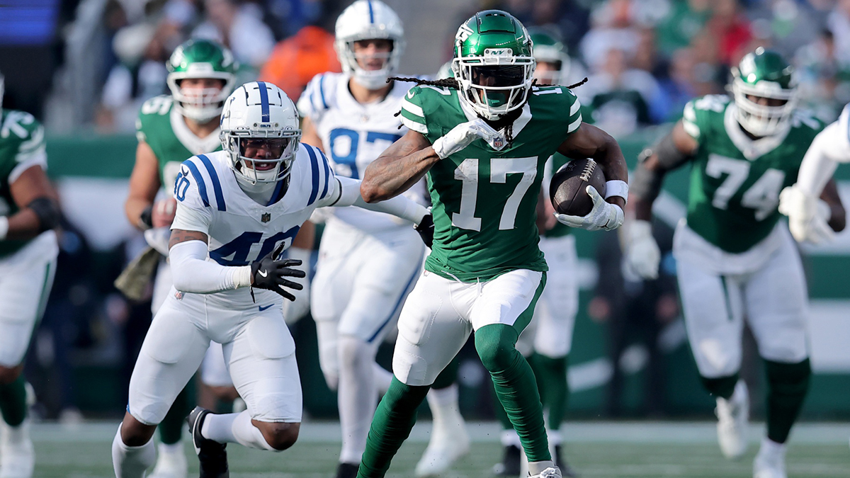 Nov 17, 2024; East Rutherford, New Jersey, USA; New York Jets wide receiver Davante Adams (17) runs with the ball against Indianapolis Colts cornerback Jaylon Jones (40) during the second quarter at MetLife Stadium. 