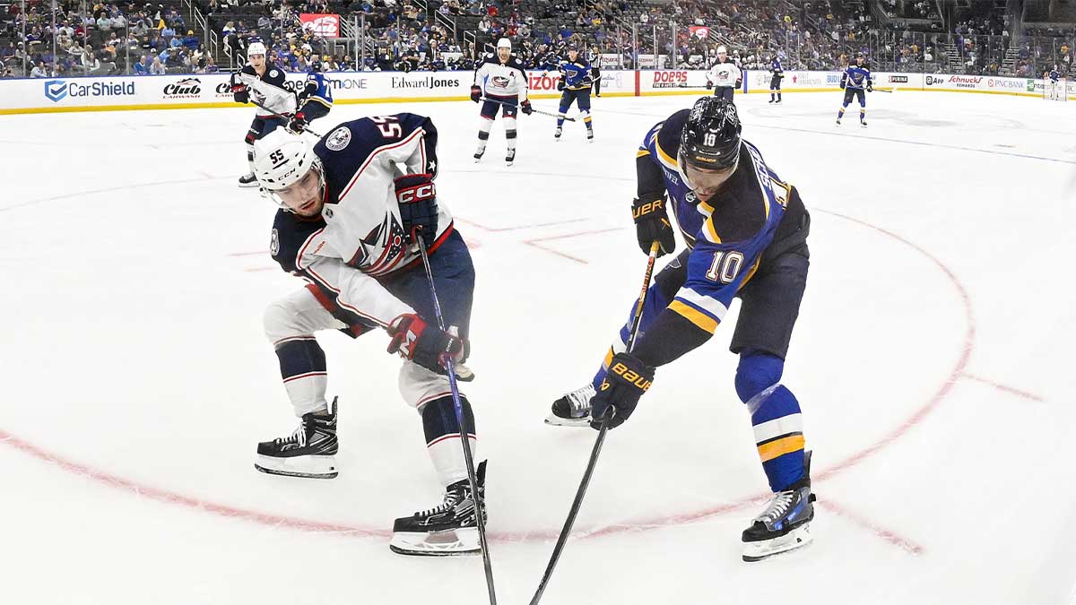 Columbus Blue Jackets defenseman David Jiricek (55) and St. Louis Blues center Brayden Schenn (10) battle for the puck during the second period at Enterprise Center.