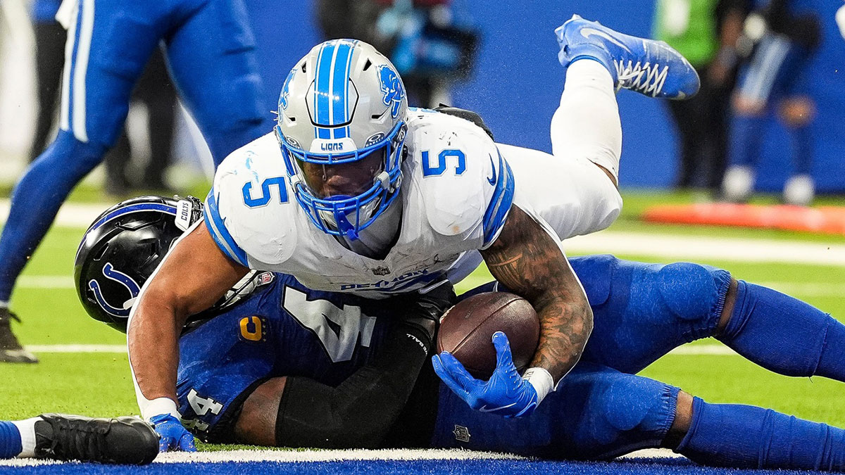 Detroit Lions running back David Montgomery (5) rolls over Indianapolis Colts linebacker Zaire Franklin (44) for a touchdown during the first half at Lucas Oil Stadium in Indianapolis, Ind. on Sunday, Nov. 24, 2024.