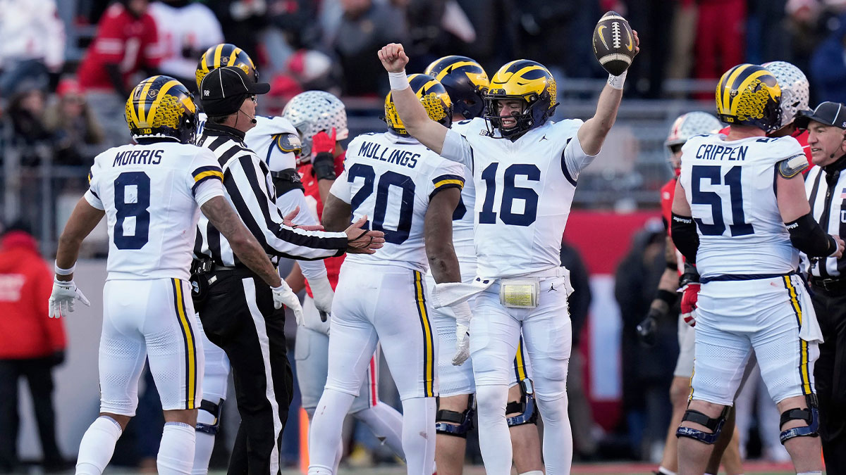 Michigan Wolverines quarterback Davis Warren (16) celebrates a 13-10 win over Ohio State Buckeyes at the end of the NCAA football game at Ohio Stadium