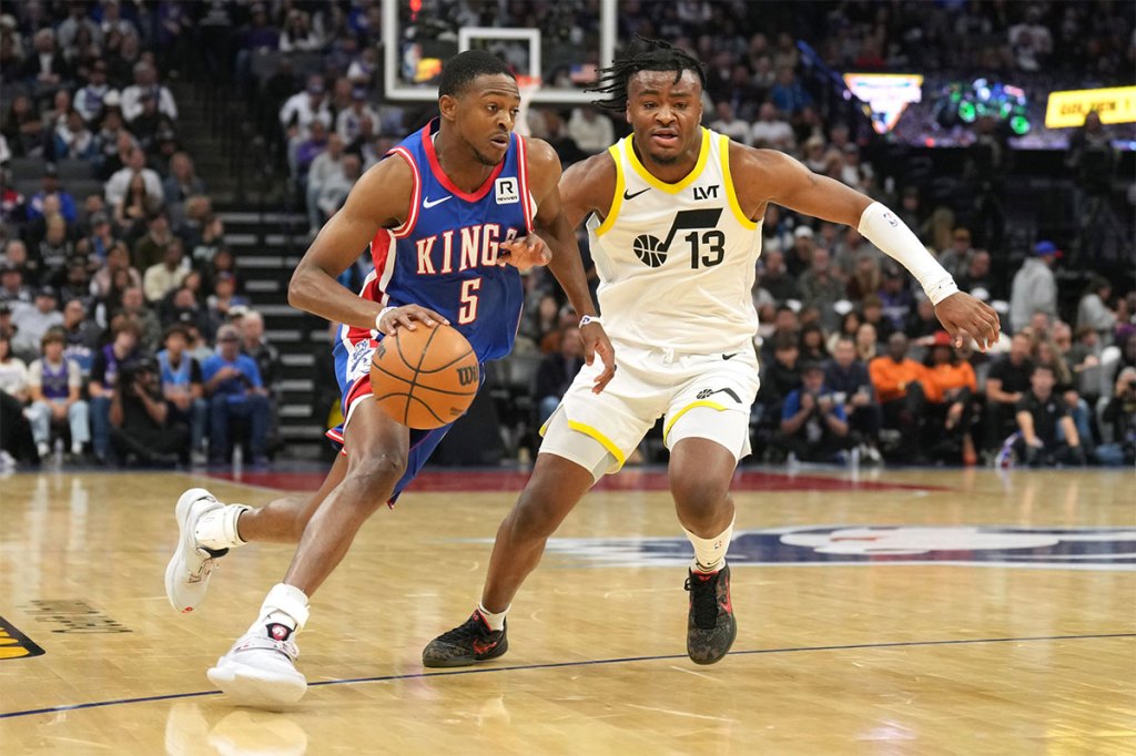 Sacramento Kings guard De'Aaron Fox (5) dribbles against Utah Jazz guard Isaiah Collier (13) during the second quarter at Golden 1 Center. 