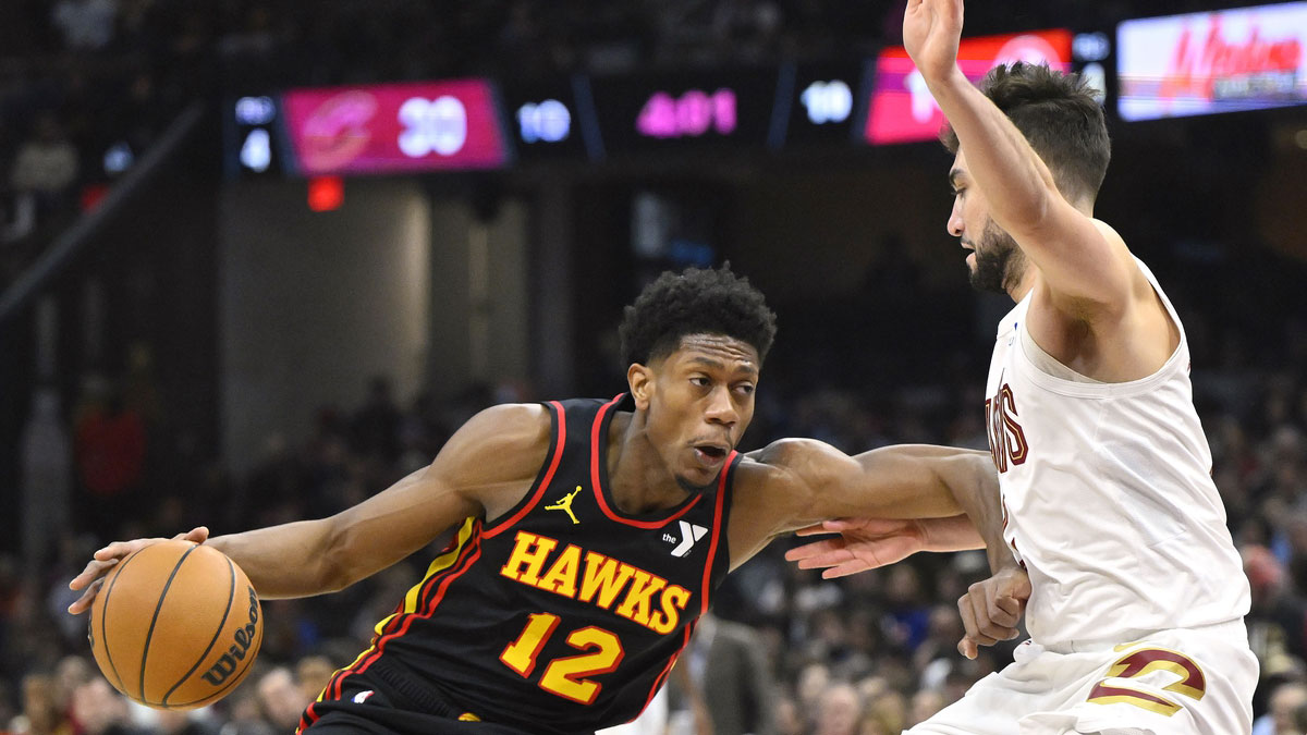 Atlanta Hawks forward De'Andre Hunter (12) drives as Cleveland Cavaliers guard Ty Jerome (2) defends in the first quarter at Rocket Mortgage FieldHouse.