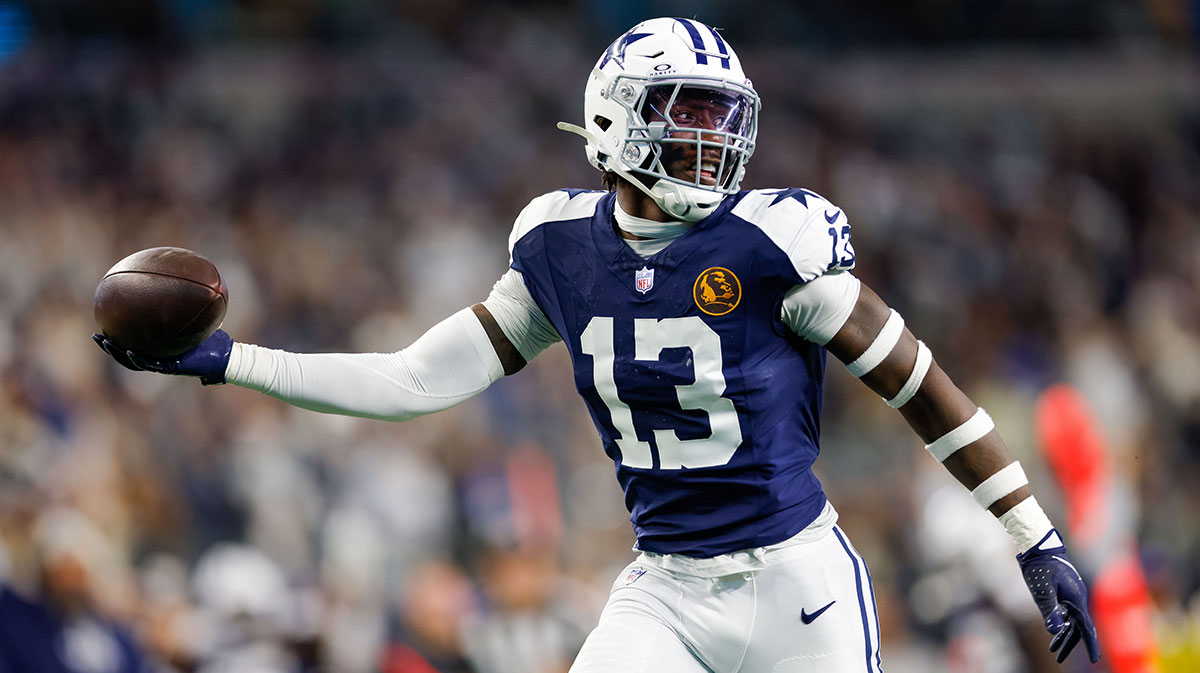 Nov 28, 2024; Arlington, Texas, USA; Dallas Cowboys linebacker DeMarvion Overshown (13) intercepts a pass and returns it for a touchdown during the second quarter against the New York Giants at AT&T Stadium.