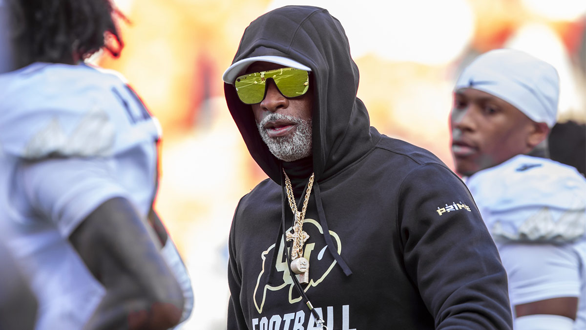 Colorado head coach Deion Sanders watches his players warmup prior to the game between the Kansas Jayhawks and the Colorado Buffaloes at GEHA Field at Arrowhead Stadium.