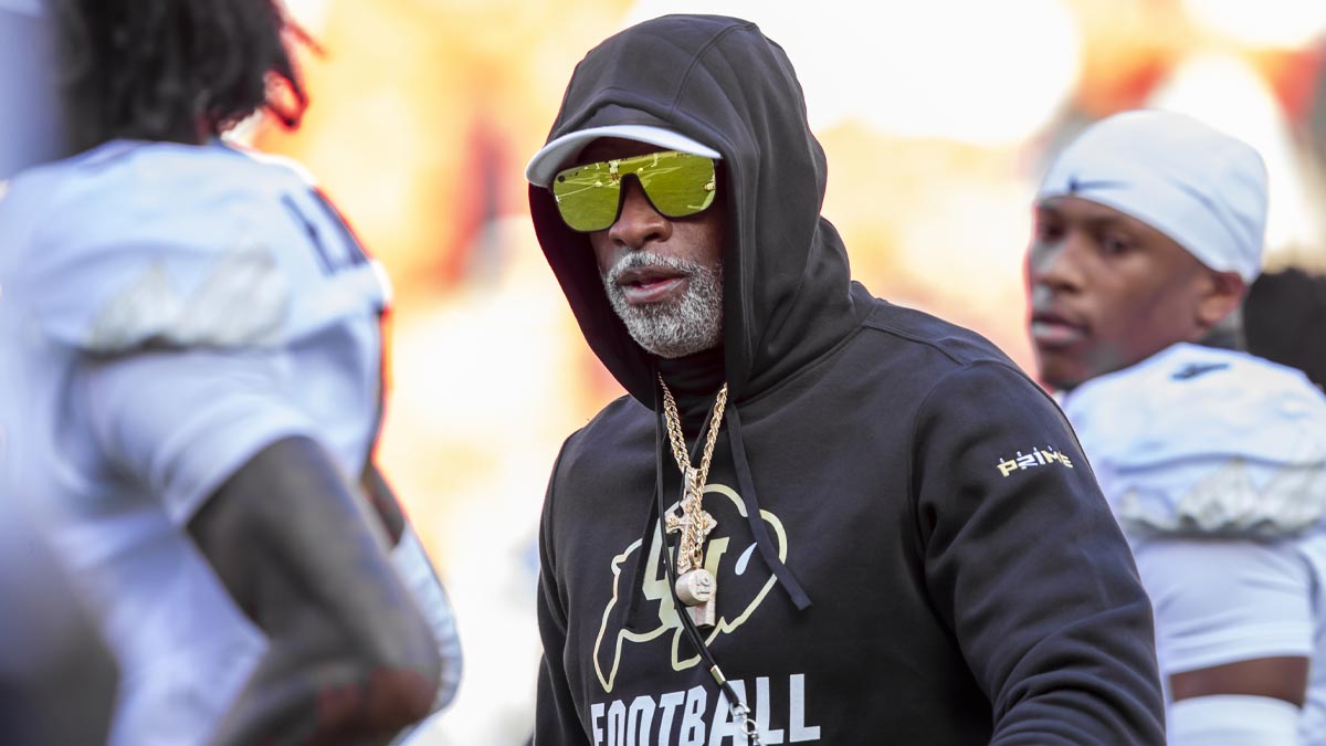 Colorado head coach Deion Sanders watches his players warmup prior to the game between the Kansas Jayhawks and the Colorado Buffaloes at GEHA Field at Arrowhead Stadium.