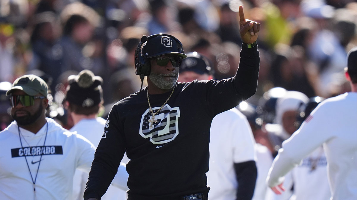 Colorado Buffaloes head coach Deion Sanders calls in a play in the first quarter against the Utah Utes at Folsom Field.