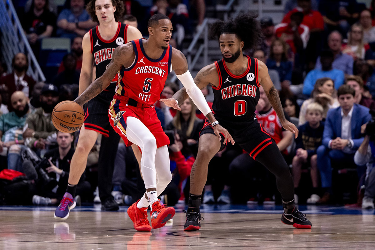 New Orleans Pelicans guard Dejounte Murray (5) dribbles against Chicago Bulls guard Coby White (0) during the first half at Smoothie King Center.