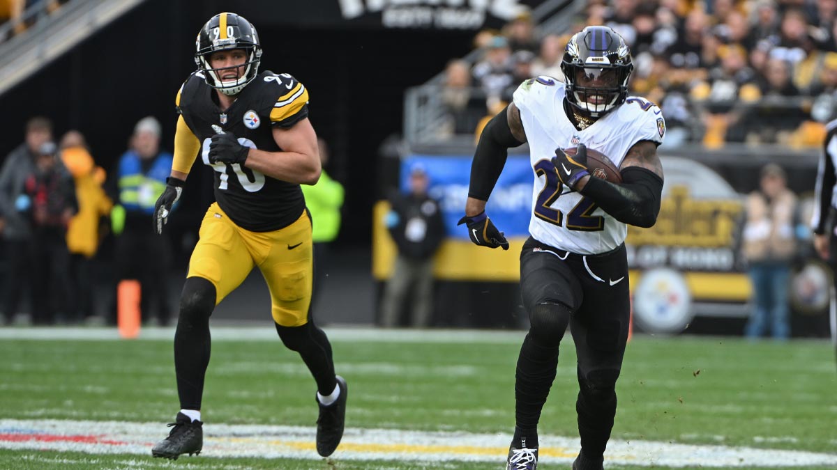 Baltimore Ravens running back Derrick Henry (22) gains yardage while being chased by Pittsburgh Steelers linebacker T.J. Watt (90) during the second quarter at Acrisure Stadium. Derrick Henry also praised Saquon Barkley for his 255-yard performance in the Week 12 game between the Eagles and Rams.