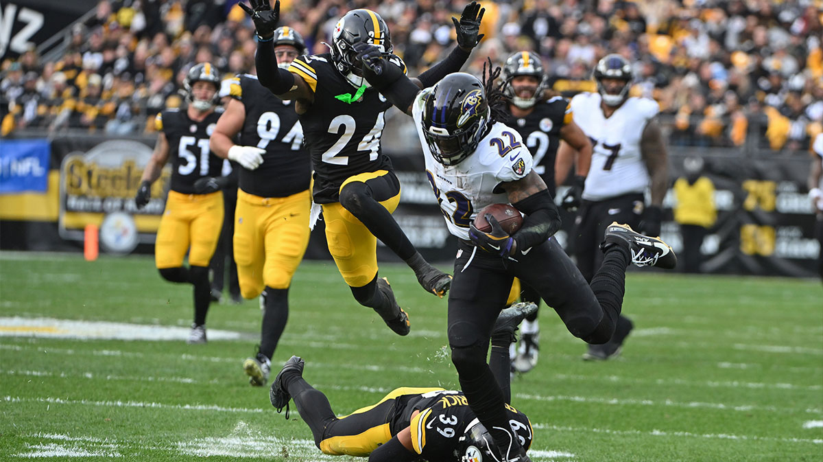 Baltimore Ravens running back Derrick Henry (22) is tackled by Pittsburgh Steelers safety Minkah Fitzpatrick (39) during the second quarter at Acrisure Stadium.