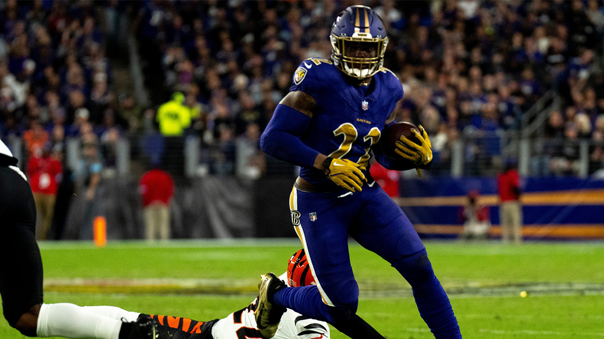 Baltimore Ravens running back Derrick Henry (22) runs by Cincinnati Bengals safety Geno Stone (22) in the second quarter of the NFL game at M&T Banks Stadium in Baltimore on Thursday, Nov. 7, 2024.