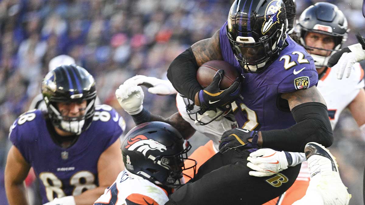 Baltimore Ravens running back Derrick Henry (22) dives over tacklers during the second half against the Denver Broncos at M&T Bank Stadium.