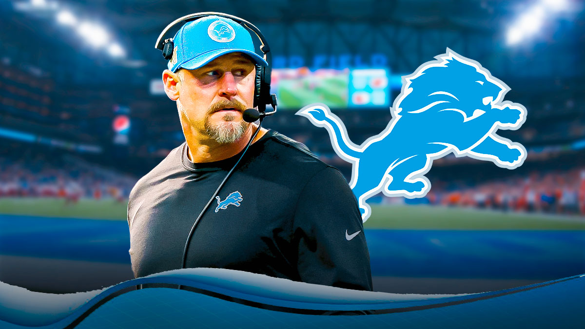 Dan Campbell looking serious next to a Lions logo