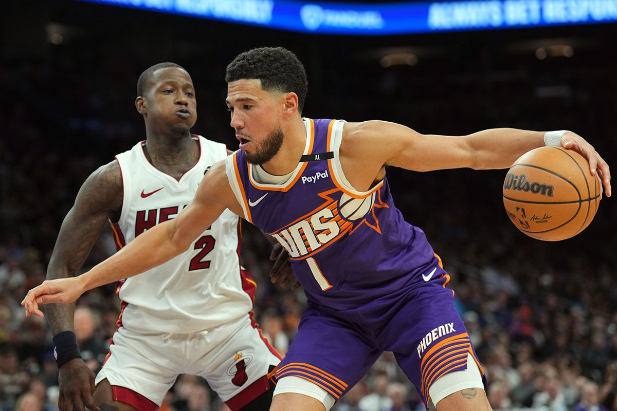 Phoenix Suns Guard Devin Booker (1) Dribbles v. Miami heat guard Terri Rozier (2) During the first half in the footprint center. 