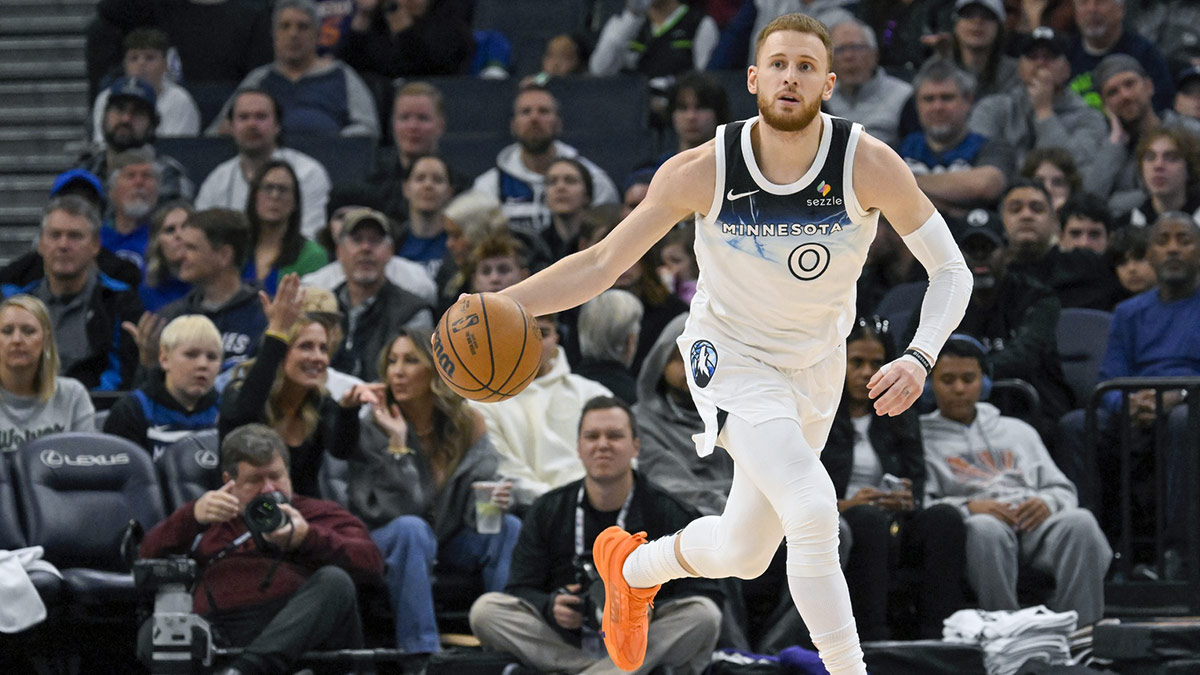 Minnesota Timberwolves guard Donte DiVincenzo (0) brings the ball up-court against the Phoenix Suns during the third quarter at Target Center.