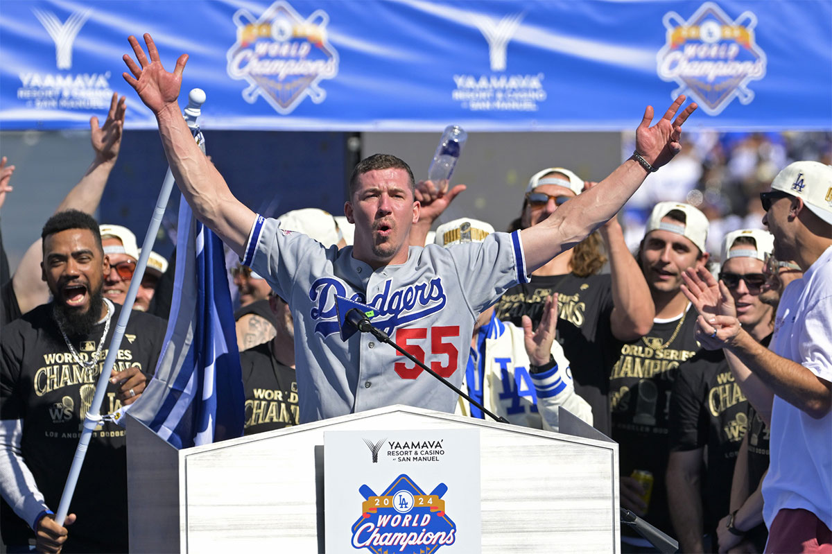 Los Angeles Dodgers starting pitcher Walker Buehler (21) speaks to fans during the World Series Championship Celebration at Dodger Stadium