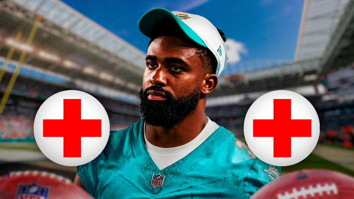 Raheem Mostert in Dolphins uniform with medical Red Cross symbol