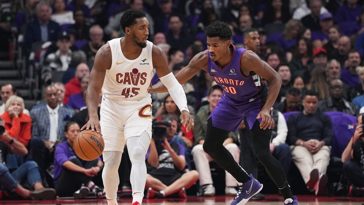 Oct 23, 2024; Toronto, Ontario, CAN; Cleveland Cavaliers guard Donovan Mitchell (45) controls the ball as Toronto Raptors guard Ochai Agbaji (30) defends during the first quarter at Scotiabank Arena.