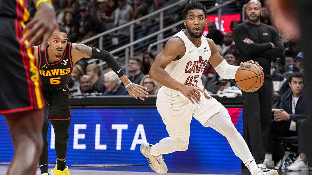 Cleveland Cavaliers guard Donovan Mitchell (45) dribbles past Atlanta Hawks guard Dejounte Murray (5) during the first half at State Farm Arena.